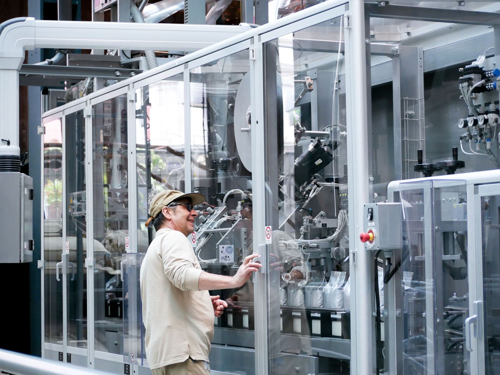 An operator at an automated packaging machine